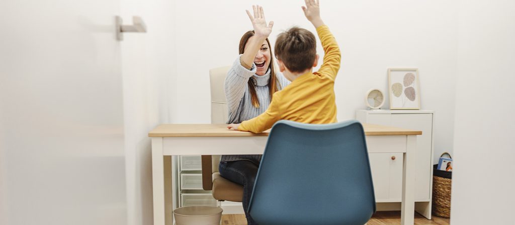 Woman and child high-fiving